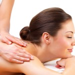 Young woman getting massage from female hands