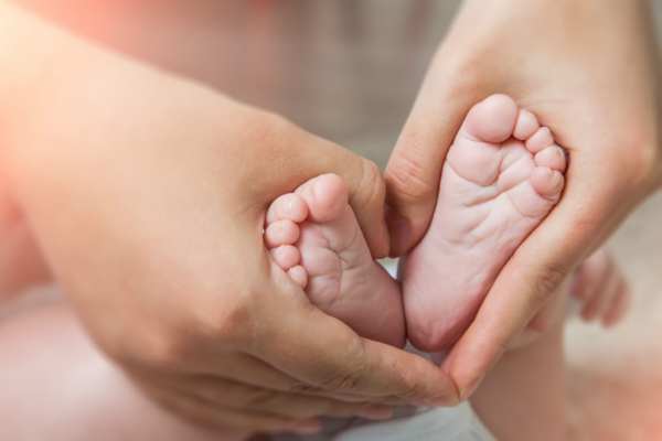 Mother holding baby's feet