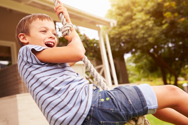 child on rope swing