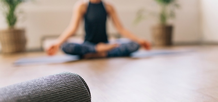 Woman doing yoga, close up of yoga mat