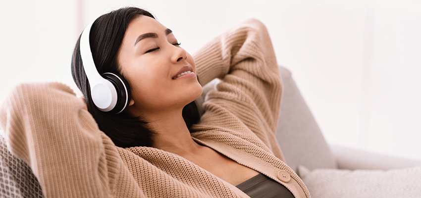 woman listening to music wearing headphones