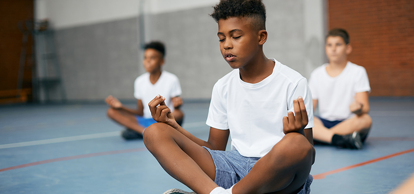 elementary students doing breathing exercise