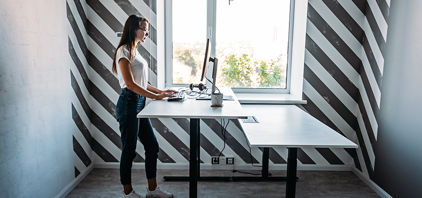 woman at stand up desk in office