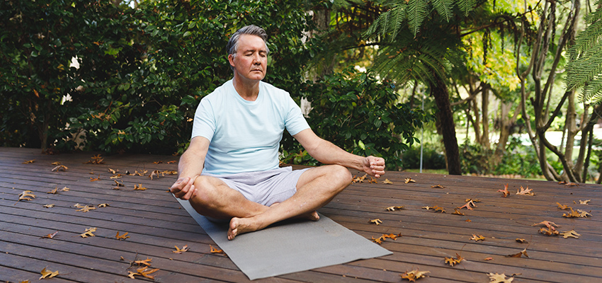 man practicing yoga outside