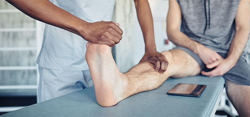 therapist making massage to patient